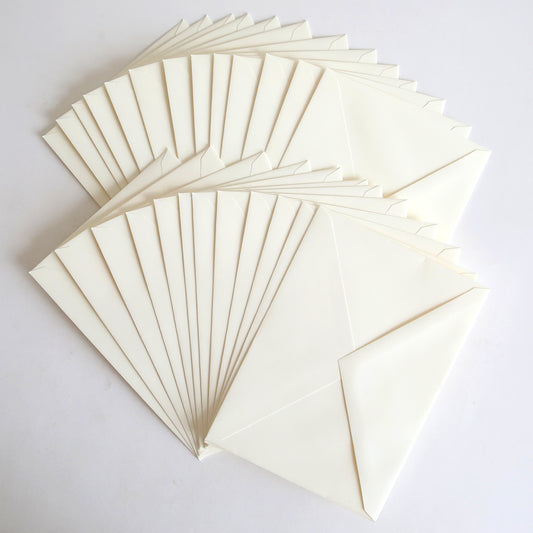 A set of 25 Natural Envelopes (5.25" x 7.25") is fanned out on a plain white surface.
