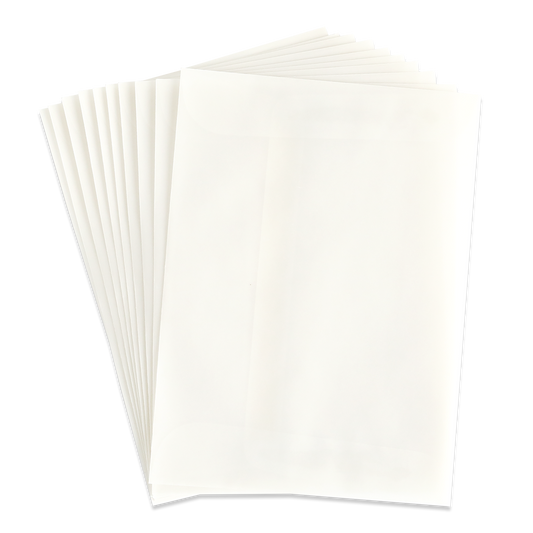 A stack of blank, white sheets of paper fanned out on a light surface—ideal for pairing with the 10 Pack Vellum A7 Envelopes (5.25″ x 7.25″) to create elegant invitations.