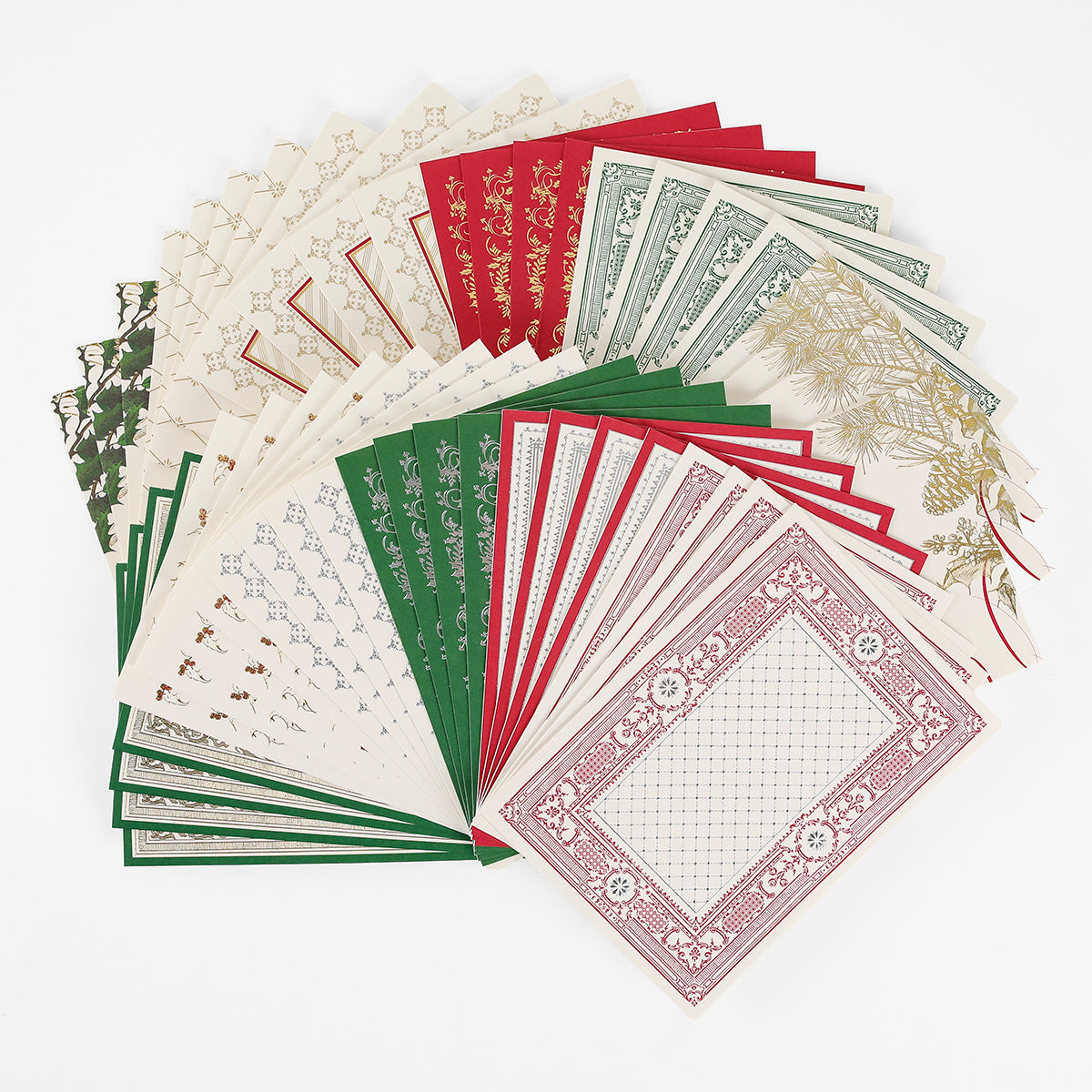 A selection of Christmas Engravings Cards and Envelopes, perfect for Christmas card making and featuring ornate holiday designs, are fanned out in a semi-circle in rich red, green, and cream colors against a crisp white background.