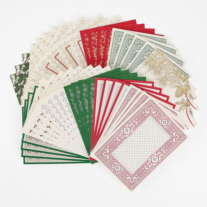 A selection of Christmas Engravings Cards and Envelopes, perfect for Christmas card making and featuring ornate holiday designs, are fanned out in a semi-circle in rich red, green, and cream colors against a crisp white background.
