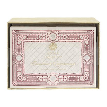 A box of Christmas Engravings Cards and Envelopes, featuring ornate red and gold detailing on the cards, partially visible through a clear box window.