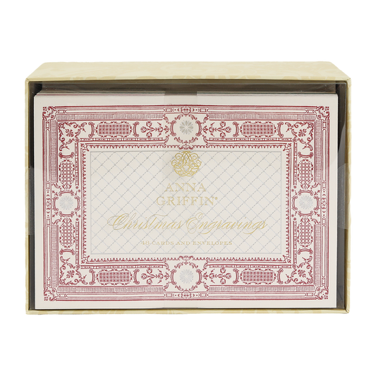 A box of Christmas Engravings Cards and Envelopes, featuring ornate red and gold detailing on the cards, partially visible through a clear box window.