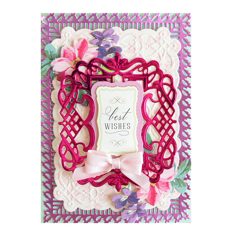 Decorative card from the Black Friday Empress Mini Bundle featuring a "Best Wishes" message. Showcases intricate pink and white patterns, flowers, and a pink bow on a purple and white background, crafted using an embossing machine for elegant detail.