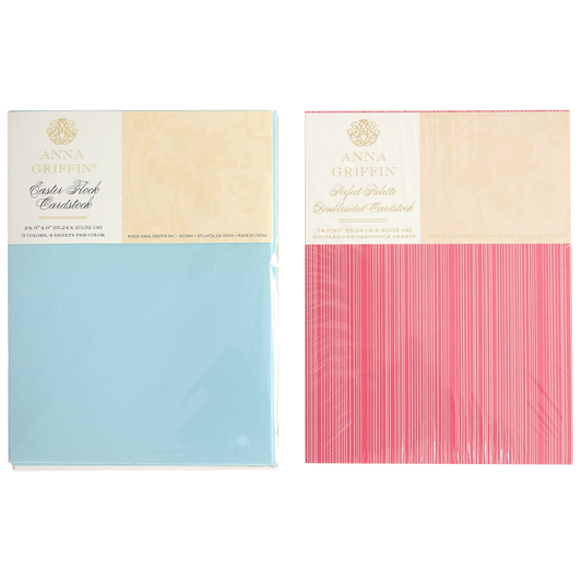 Two packs of Anna Griffin cardstock—light blue "Satin Stock" and pink "Stylish Stripes"—sealed in plastic and designed to coordinate seamlessly with the Perfect Palette Flocked and Printed Cardstock for stunning cardmaking projects.