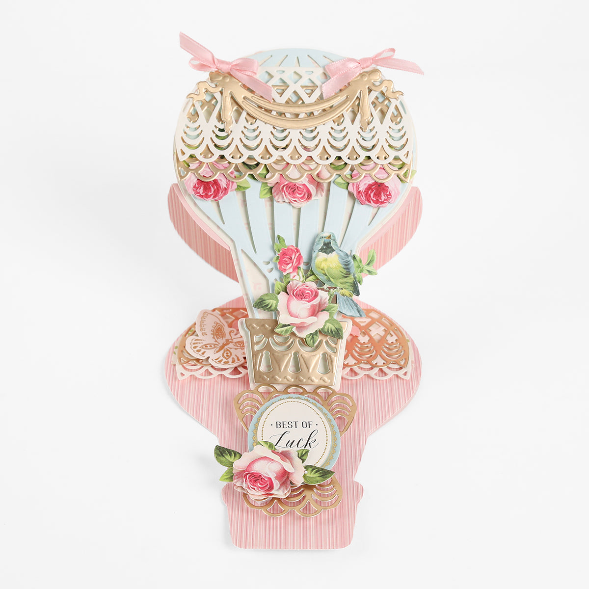 Created with the Hot Air Balloon Easel Die, this decorative card features a charming hot air balloon shape adorned with pink roses, a bird, and “Best of Luck” text. Accented with ribbons and detailed cutouts, it’s perfect for handmade cards and adds an elegant touch to your crafting projects.