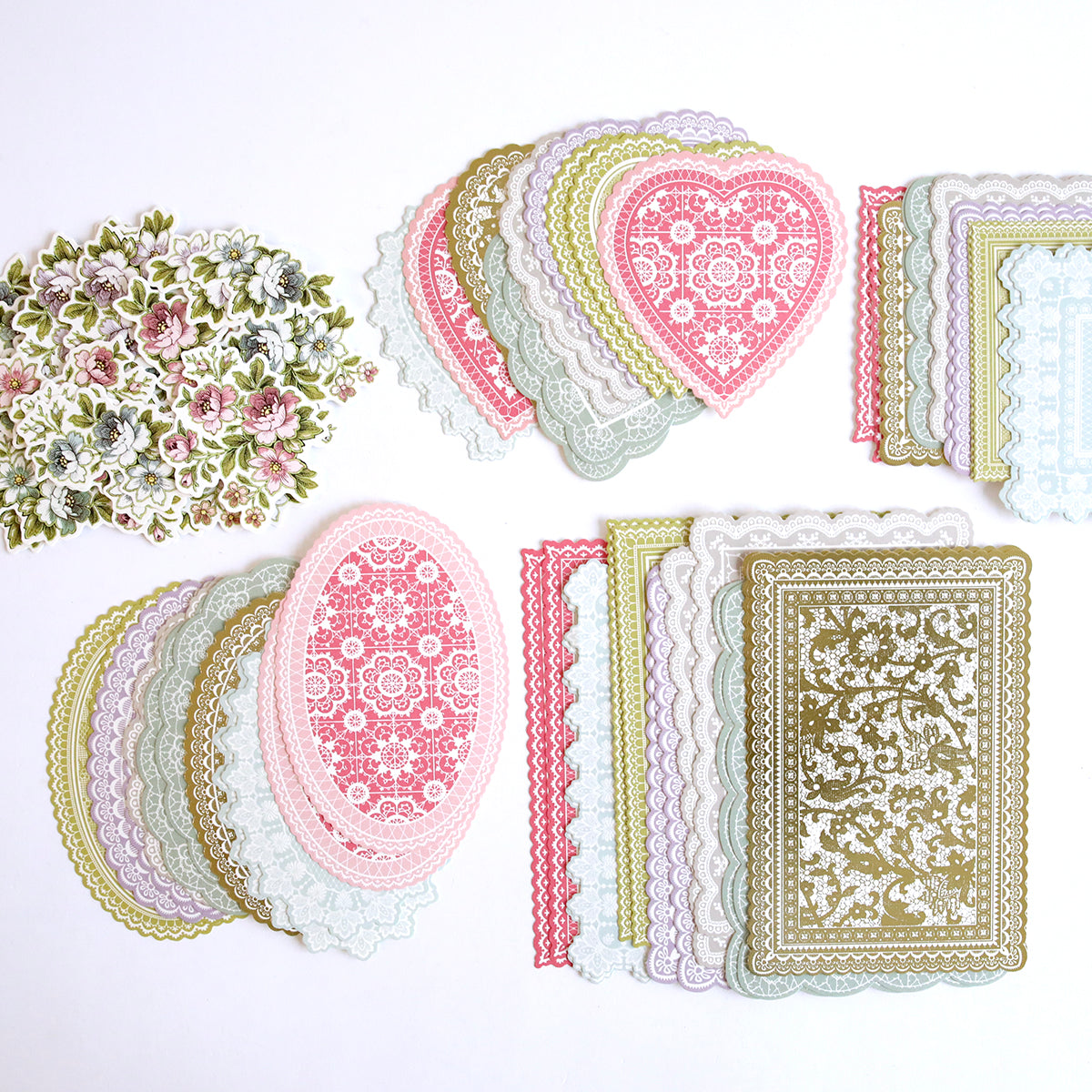 Lace Doily Embellishments, Cards, and Envelopes are tastefully set on a white surface, serving as charming decorative elements.