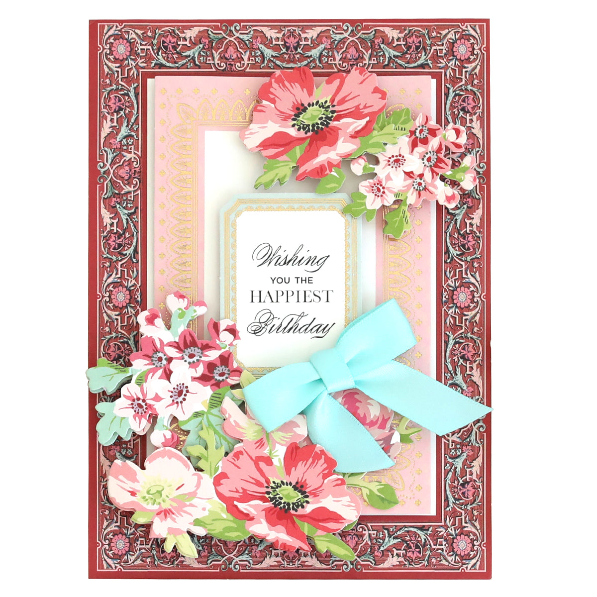 A beautifully designed birthday card featuring floral motifs and accented with a blue ribbon, along with the heartfelt message "Wishing You the Happiest Birthday," making it an ideal choice from the Lace Doily Embellishments, Cards and Envelopes collection to add a personal touch.