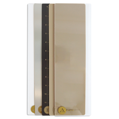Four rectangular color sample cards labeled I, E, C, and A are stacked vertically in shades from black to beige, resembling the Empress Mini 13" Full Plate Set die cutting plates.