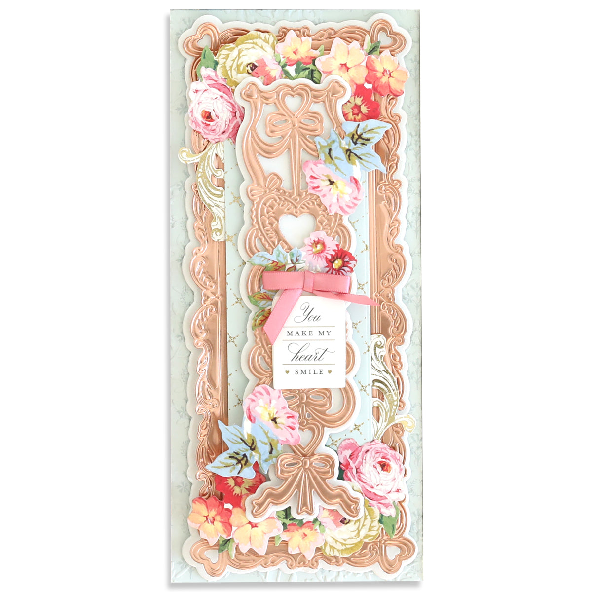 An exquisite card embellished with pink and orange flowers, intricate patterns, and a pink bow showcases the elegance of the Slimline Hearts Dies and Cut Emboss Folders. Delicate hearts accentuate the corners, while a central message reads, "You make my heart smile.