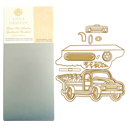A package of Christmas Truck Easel Dies and Cardstock next to metal craft dies shaped like a vintage truck, a wreath, and decorative elements for a vintage-inspired Christmas card.