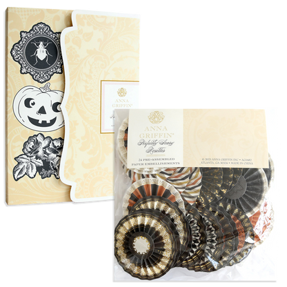 Two packs of Perfectly Scary Halloween Embellishments with vintage Halloween designs and assorted black, orange, and gold rosettes—ideal for spooky crafts.