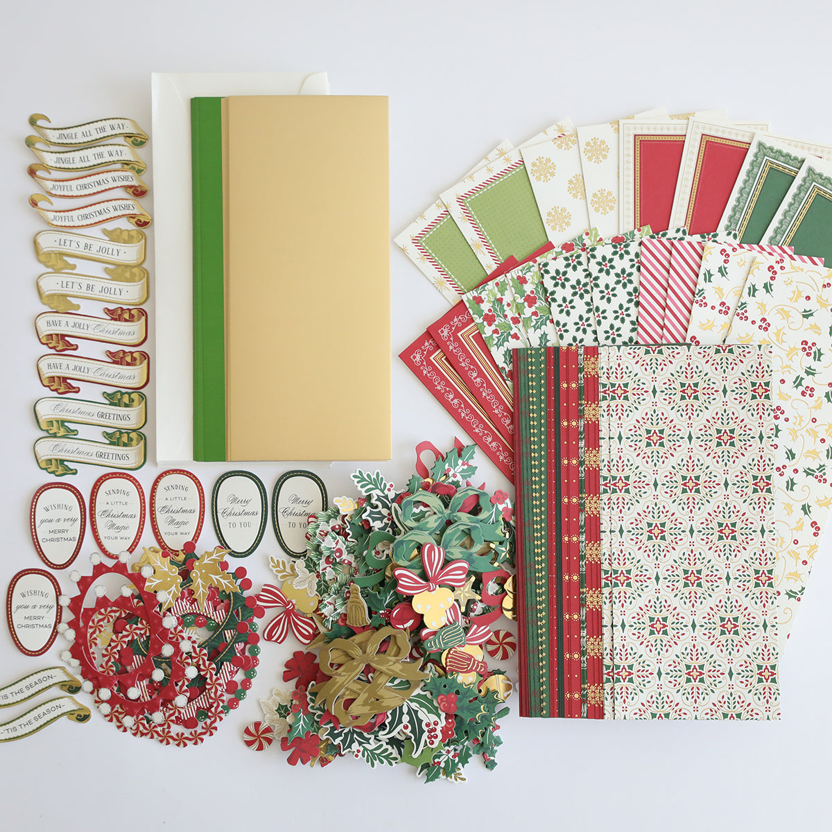 A variety of holiday-themed crafting supplies from the Paper Elf Shoe Finishing School Refill Kit, including festive paper designs, decorative borders, die-cut shapes, tags, and 3D sentiments, all laid out on a white background.