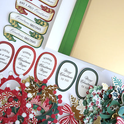 The Paper Elf Shoe Finishing School Refill Kit includes a collection of Christmas-themed stickers with phrases like "Have a Jolly Christmas" and "Your Christmas to You," adorned with decorative holly, wreath designs, and 3D sentiments that add an extra layer of festive embellishments.