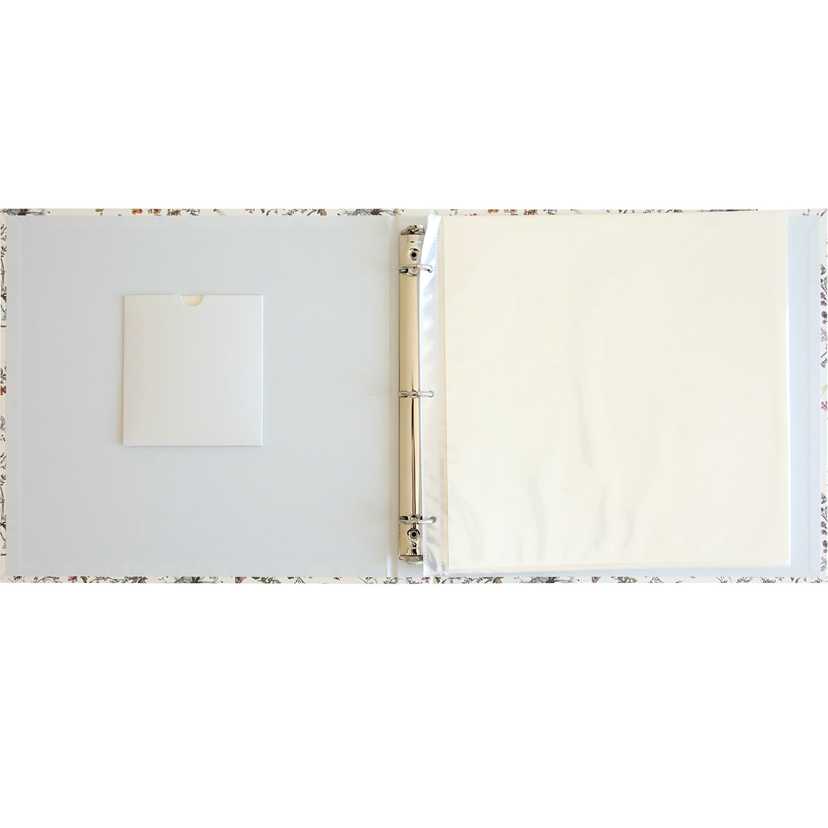 Image of an open three-ring binder with an empty clear plastic sheet on the right and a white pocket on the left, perfect for safeguarding your memories. Use page protectors to keep your keepsakes pristine in this Wildflower Meadow Scrapbook Album.