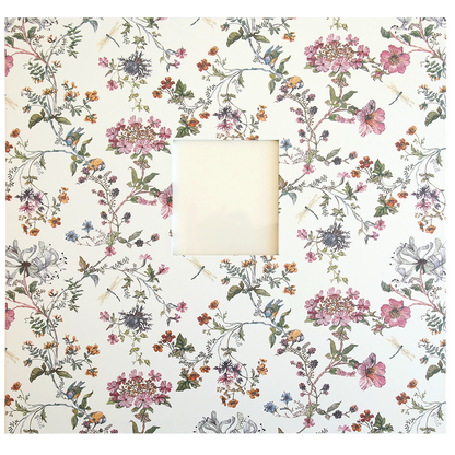 A square white frame with an intricate floral pattern featuring various flowers and leaves, reminiscent of memories captured in a Wildflower Meadow Scrapbook Album, surrounds a small blank square in the center.