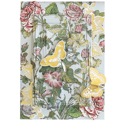 A decorative greeting card with a floral background featuring pink and yellow flowers and two yellow butterflies. The card, reminiscent of a Wildflower Meadow Papercrafting Kit, has an intricate, layered design creating a 3D effect.