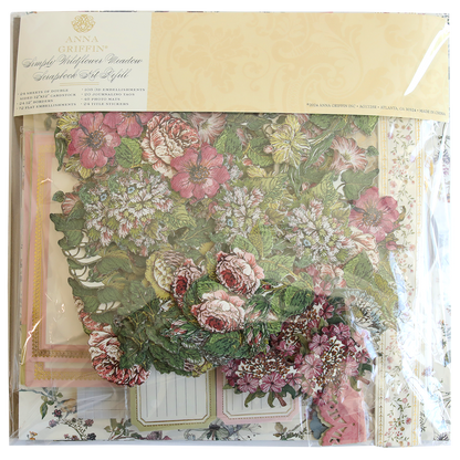 A packaged set of Wildflower Meadow Papercrafting Kit featuring floral-themed die cuts, decorative papers, and embellishments suitable for creating handmade cards. Arranged neatly in a clear plastic bag with a branded label at the top.