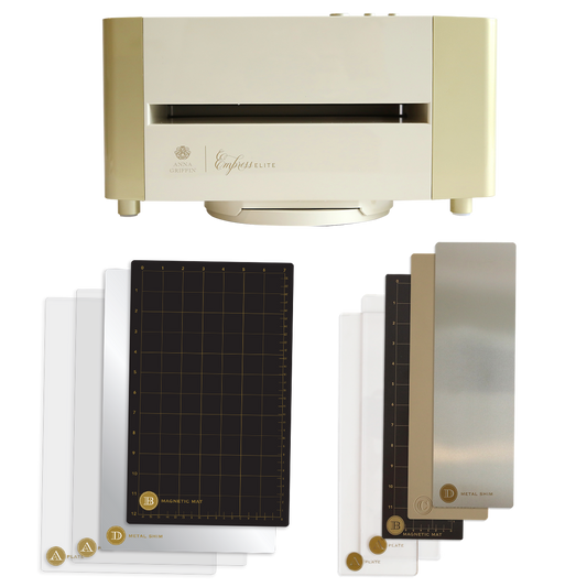 An Empress Elite Machine with Large and 13" Plates in gold and cream is displayed with four cutting plates, two metal shims, and two plastic shims neatly arranged below it.