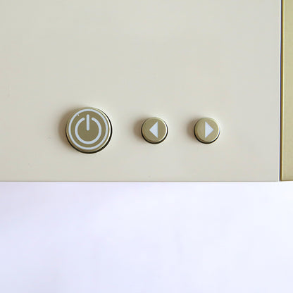 Close-up of three buttons on a light-colored surface: a large circular power button symbolizing control, reminiscent of the sleek design found on an Empress Elite Machine with Large Plates, flanked by smaller round buttons with left and right arrows.