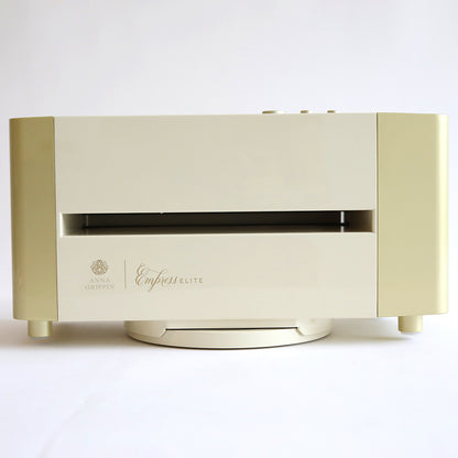 The elegant Empress Elite Machine with Large Plates, finished in sleek white and gold, stands regally against a pristine backdrop, serving as both an advanced die-cutting and embossing machine for your creative projects.