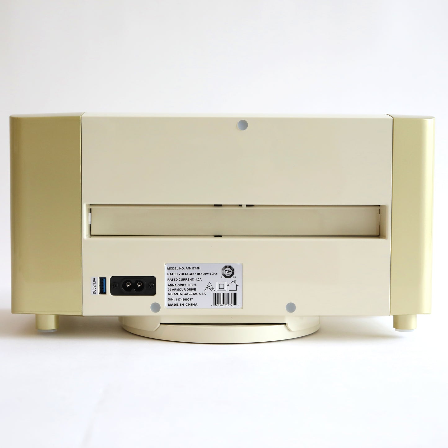 The Empress Elite Machine with Large Plates is a cream-colored, box-shaped electronic device that comes with a slot and various ports, along with a label on the back that details its specifications.