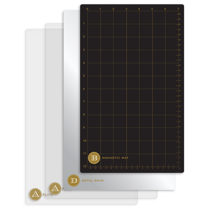 Three transparent plates labeled "A", "A", and "D" are stacked next to a black magnetic mat with gold grid and measurements, designed to be used with the Empress Elite Machine with Large and 13" Plates or any electronic die cutting machine.
