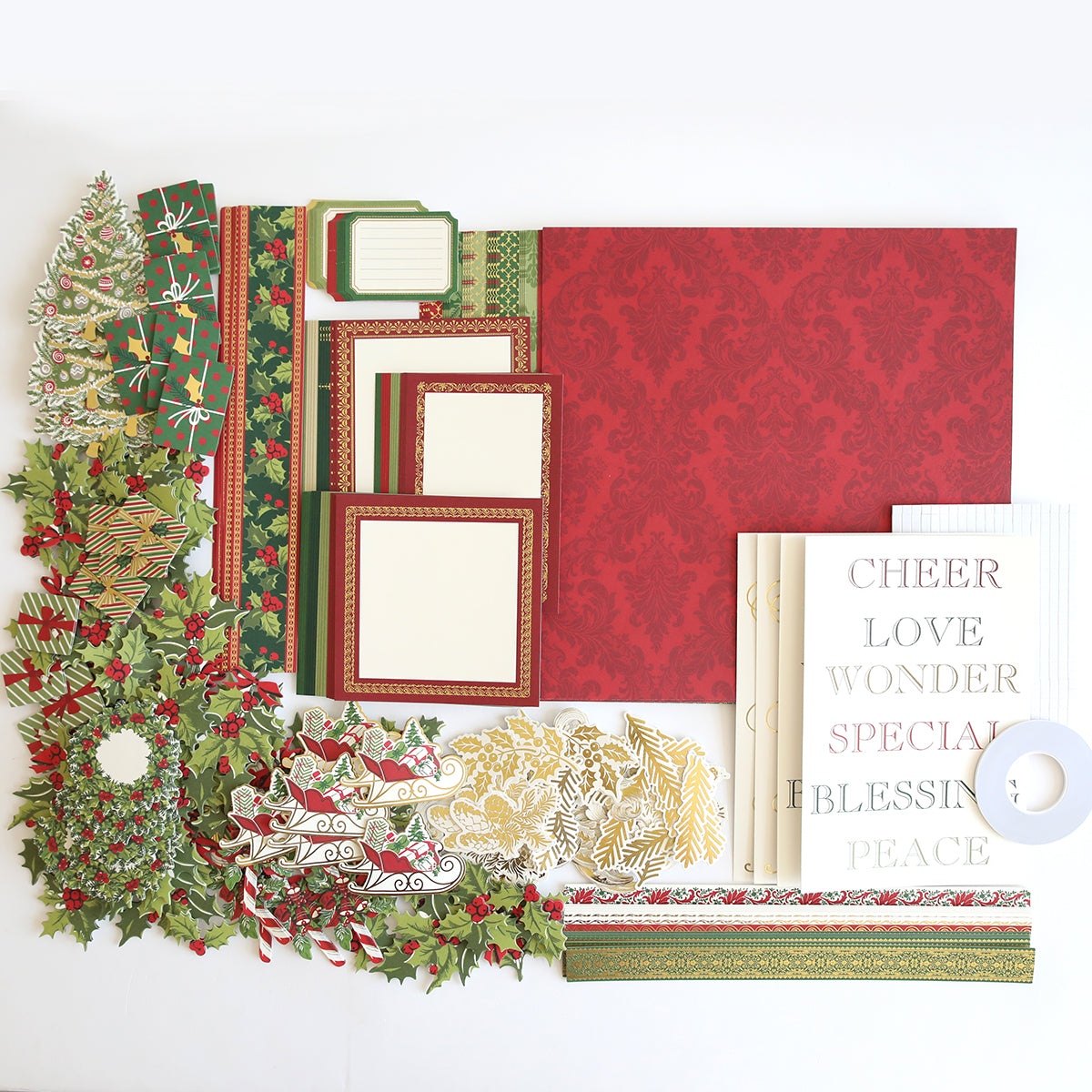 A flat lay of assorted Christmas-themed crafting materials, including festive double-sided cardstock, decorative borders, stickers, and cutouts with words like "CHEER" and "LOVE." Simply Noel Papers and Embellishments add the perfect finishing touches to your holiday projects.