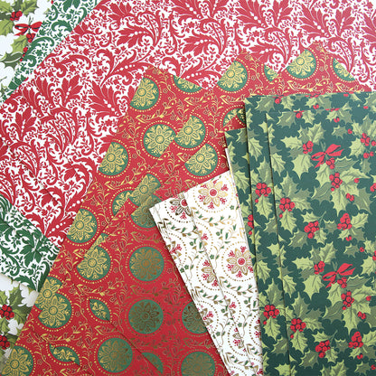 A variety of Christmas-themed wrapping papers in red, green, and white, featuring festive patterns of holly leaves, berries, and intricate designs; perfect for adding Simply Noel Papers and Embellishments or creating Double Sided Cardstock crafts.