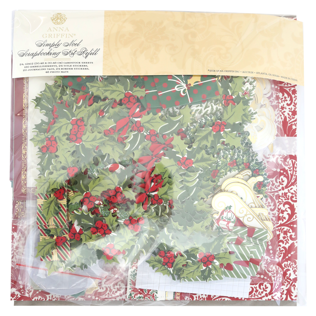 A package of Simply Noel Papers and Embellishments, including holly designs, ornaments, and double-sided cardstock in festive colors. The clear packaging features an ornate gold label at the top.