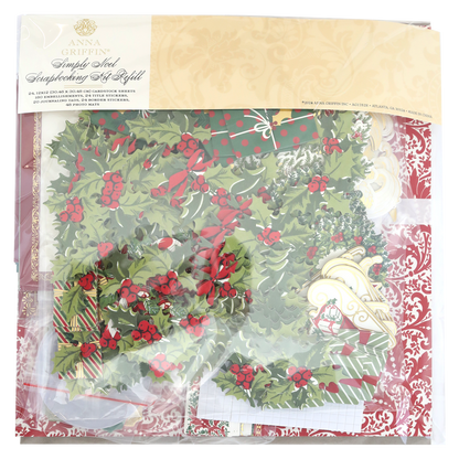 A package of Simply Noel Papers and Embellishments, including holly designs, ornaments, and double-sided cardstock in festive colors. The clear packaging features an ornate gold label at the top.