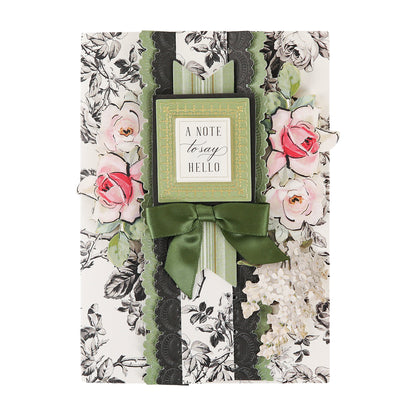 Crafted from premium Toile Doublesided 300gsm Cardstock for lasting quality, this elegant greeting card features a floral design of pink and white roses, accented by a green bow and a gold-bordered label with the message “A note to say hello” on the front. Thoughtful and refined, it makes every sentiment special.