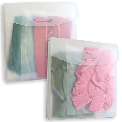 Two translucent plastic envelopes containing Perfect Palette Fringe for Every Season, each with folded lengths of green and pink Christmas fringe trim.