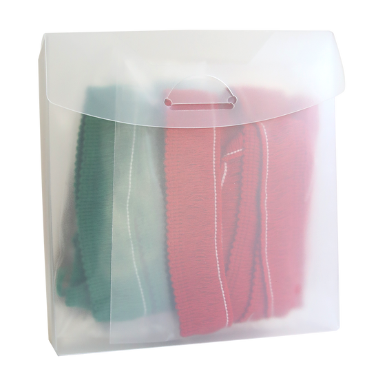 Translucent plastic pouch containing folded green and red fabric with visible white stitching, embodying the Christmas Perfect Palette Fringe.