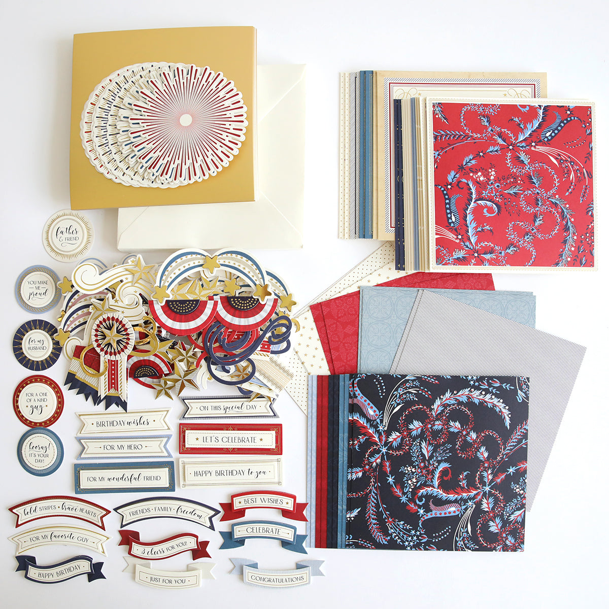 A variety of scrapbooking supplies are neatly arranged in the Celebration Chest Craft Box Refill, including patterned papers, colorful cardstock, decorative stickers, intricate die cuts with celebratory messages, and shimmering foil embellishments.