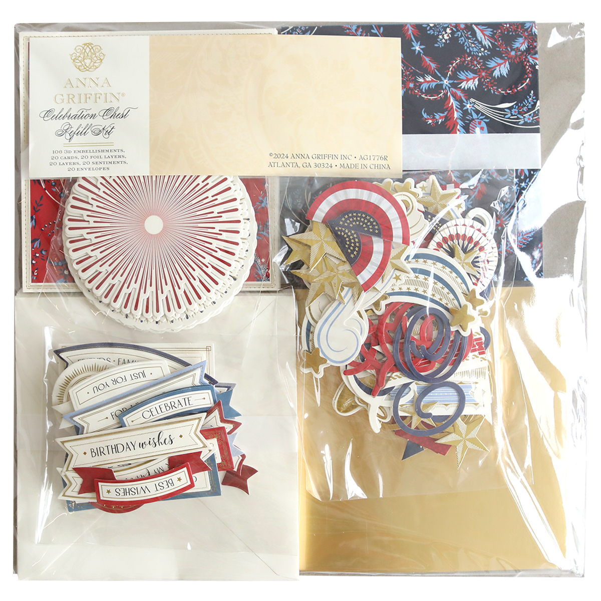 A sealed Celebration Chest Craft Box Refill containing various crafting supplies, including circular cutouts, patriotic-themed designs, foil embellishments, and banners with phrases like “Celebrate” and “Birthday Wishes.”