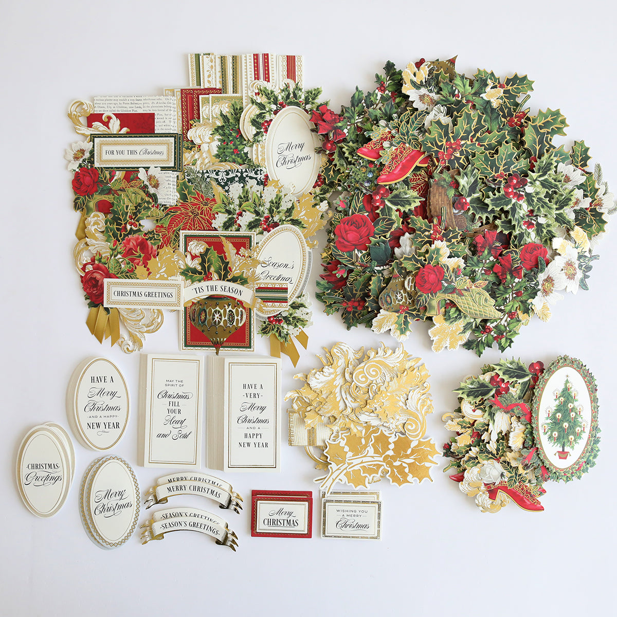 A Christmas Greetings Refill Kit featuring a festive collage of card toppers and embellishments arranged on a white background, including wreaths, holly, seasonal messages, and gift tags.