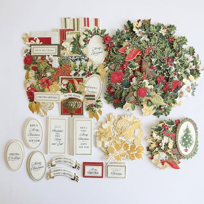 A Christmas Greetings Refill Kit featuring a festive collage of card toppers and embellishments arranged on a white background, including wreaths, holly, seasonal messages, and gift tags.