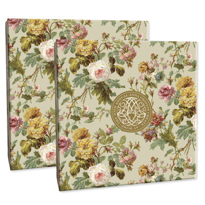 Two exquisite boxes embellished with a floral pattern of roses and green leaves, each showcasing a central circular gold emblem. These beautiful pieces are included in the Create 10 Boxes, Dies and Materials set, perfect for storing supplies to craft unique cards.