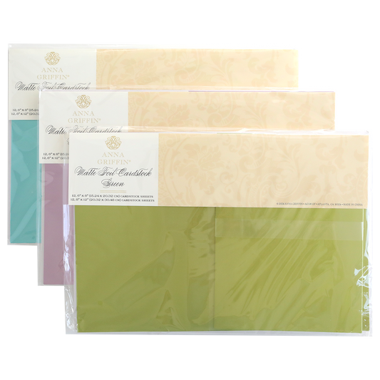 A Set of 3 Luxury Matte Foil Cardstock in lavender, blue, and green—ideal for embossing or die-cutting—is neatly stacked and sealed in clear plastic packaging.