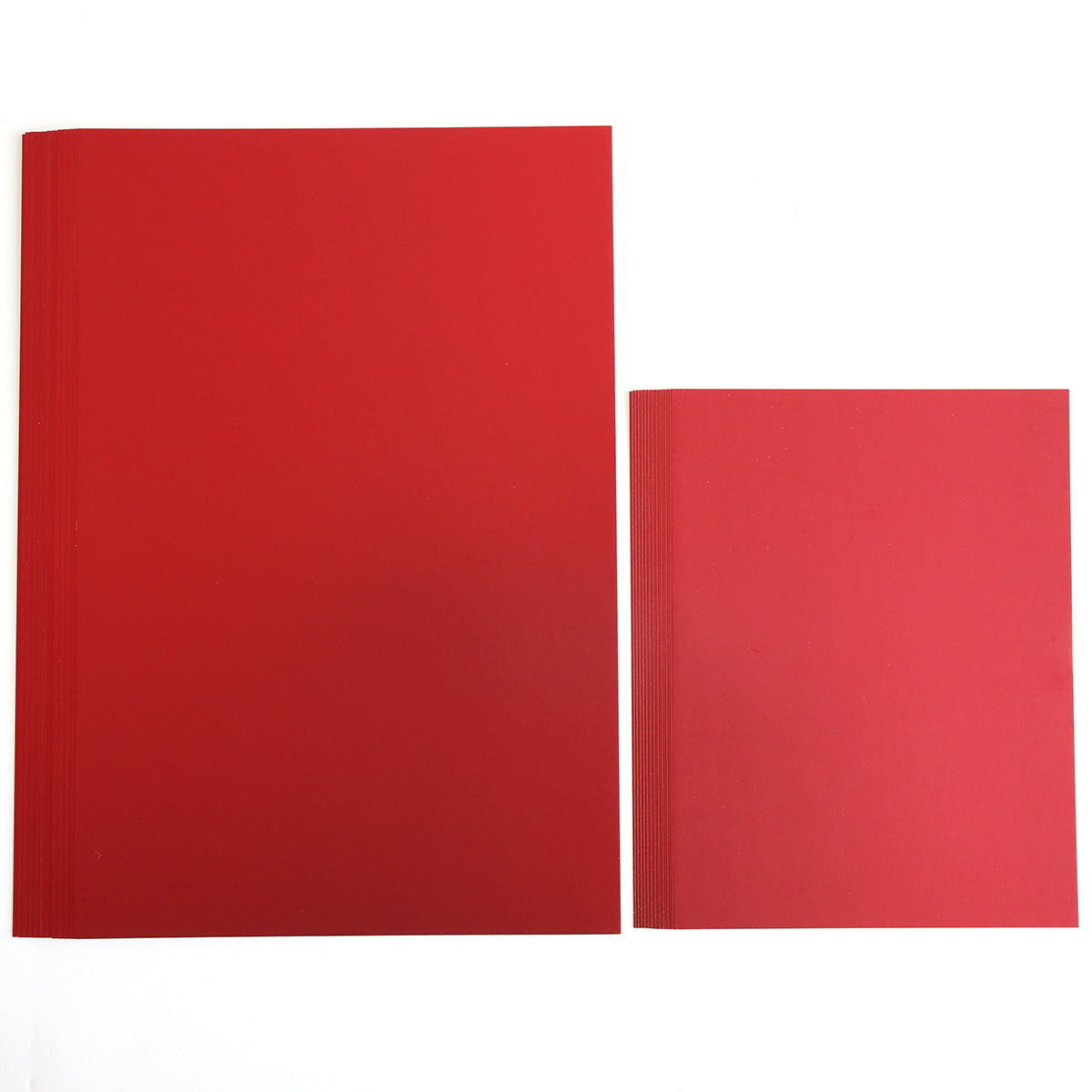 A large notebook adorned with Luxury Matte Foil Cardstock in red and a smaller one rest gracefully side by side on a white background, their textures subtly highlighted.