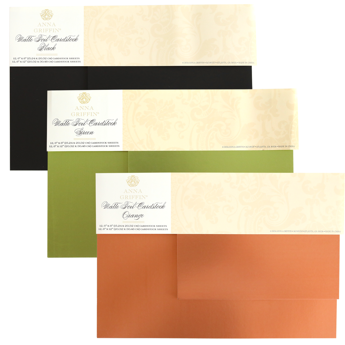 Three packs from the Fall Matte Foil Cardstock Bundle are displayed in black, green, and orange, each wrapped with a cream-colored band featuring the brand name and product details. Ideal for die cutting cardstock, these card making supplies bring an elegant touch to any project.