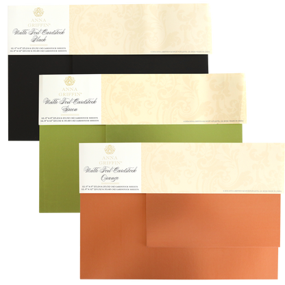 Three packs from the Fall Matte Foil Cardstock Bundle are displayed in black, green, and orange, each wrapped with a cream-colored band featuring the brand name and product details. Ideal for die cutting cardstock, these card making supplies bring an elegant touch to any project.
