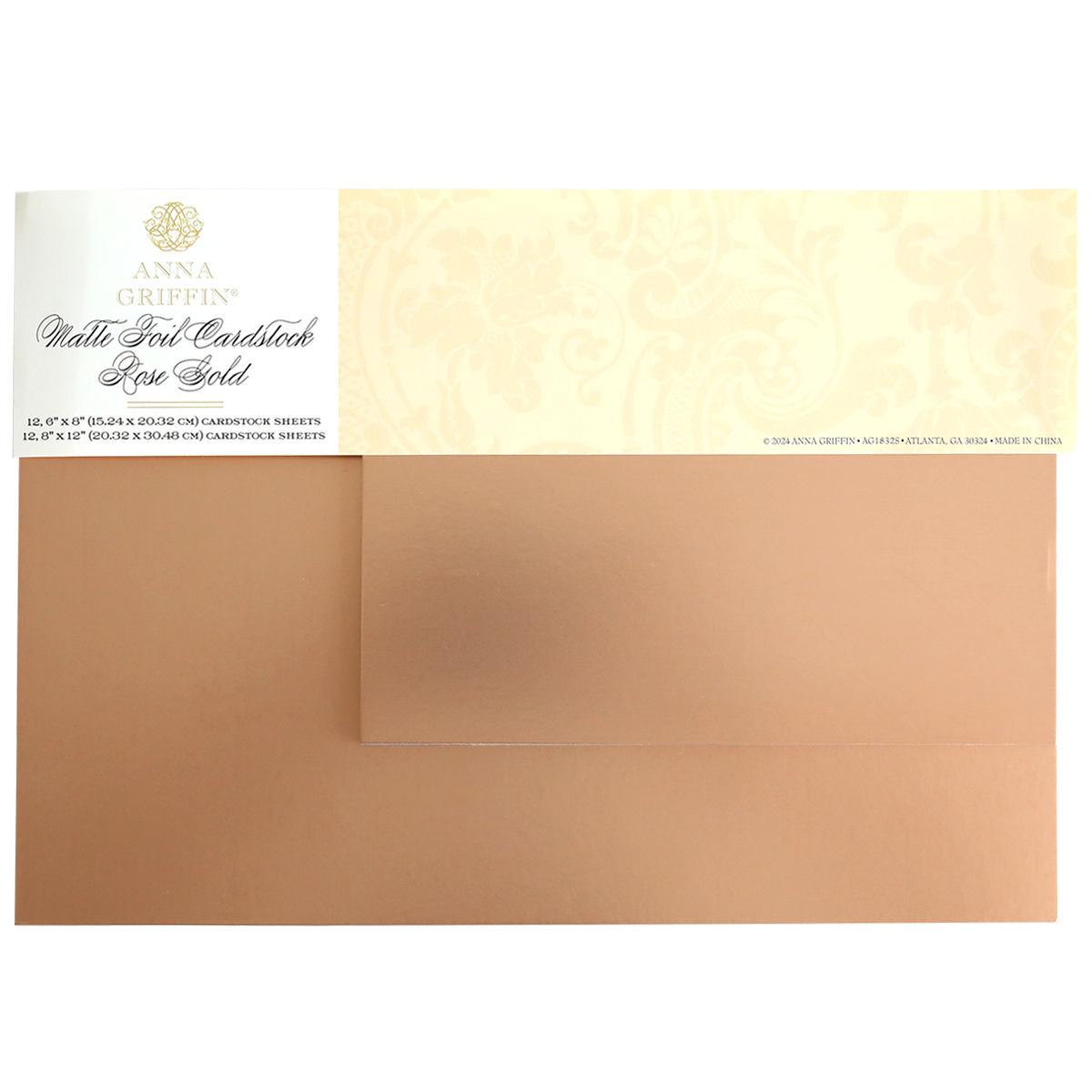 Two sheets of Luxury Matte Foil Cardstock Rose Gold partially overlap, featuring a decorative Anna Griffin label on the top left—ideal for embossing or die-cutting elegant crafts.