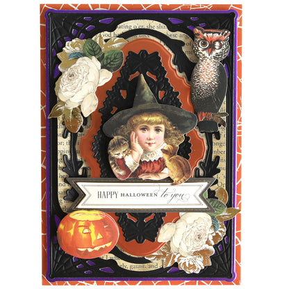 A decorative Halloween card on Luxury Matte Foil Cardstock Black featuring a girl in a witch costume with a cat, an owl, a jack-o'-lantern, white flowers, and an embossed "Happy Halloween to you" message.