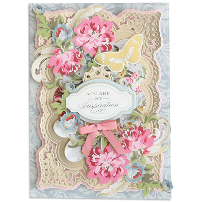 A decorative greeting card with layered floral designs, a yellow butterfly, a pink bow, and a "You are my inspiration" label on an ornate background crafted from Luxury Matte Foil Cardstock Champagne and Black.