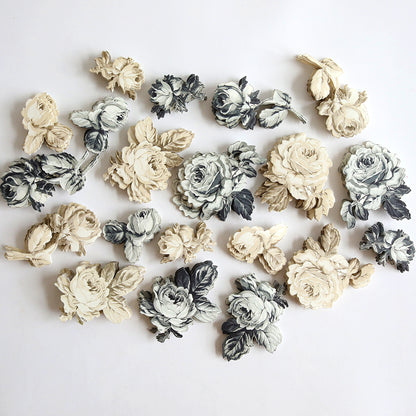 The Black and Cream Flower Stickers, featuring a mix of black, white, and beige paper flower cutouts arranged randomly on a plain white background, make the perfect embellishment for scrapbook pages.