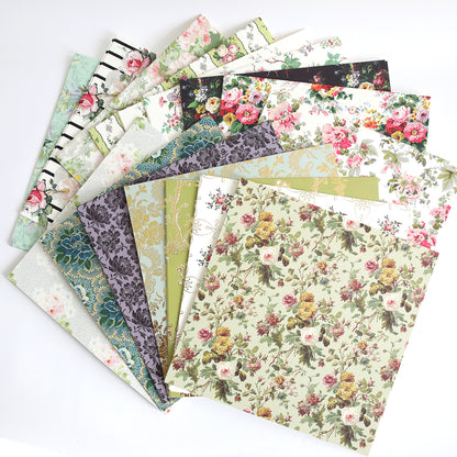 The Floral Paper Anthology features floral-patterned cardstock sheets, ideal for crafting beautiful scrapbooks or handmade cards, displayed in a fan-like spread.