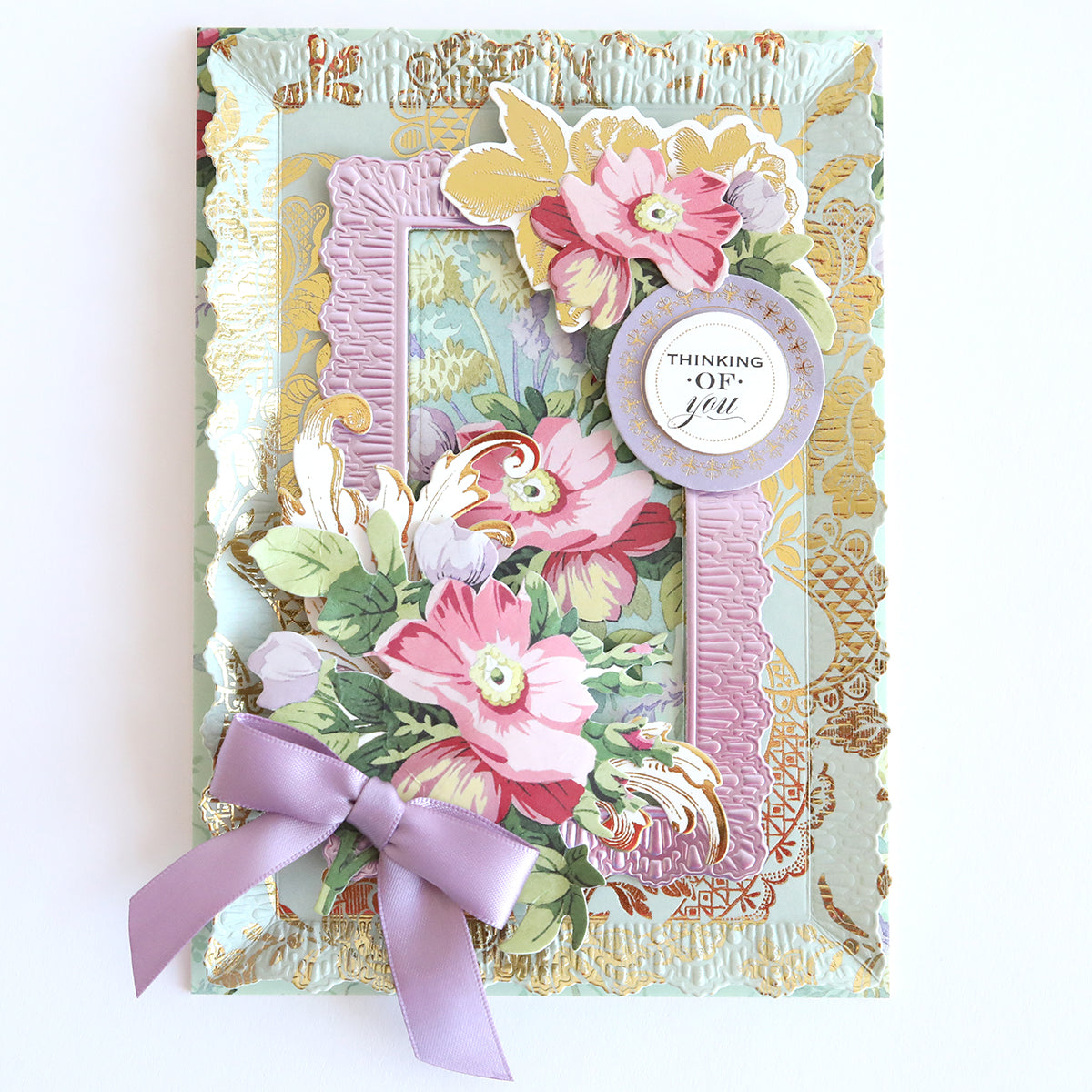 The Floral Paper Anthology card is crafted from floral cardstock with layered designs, featuring a "Thinking of You" message and a purple ribbon bow. Ideal for scrapbooks or as an elegant handmade card.