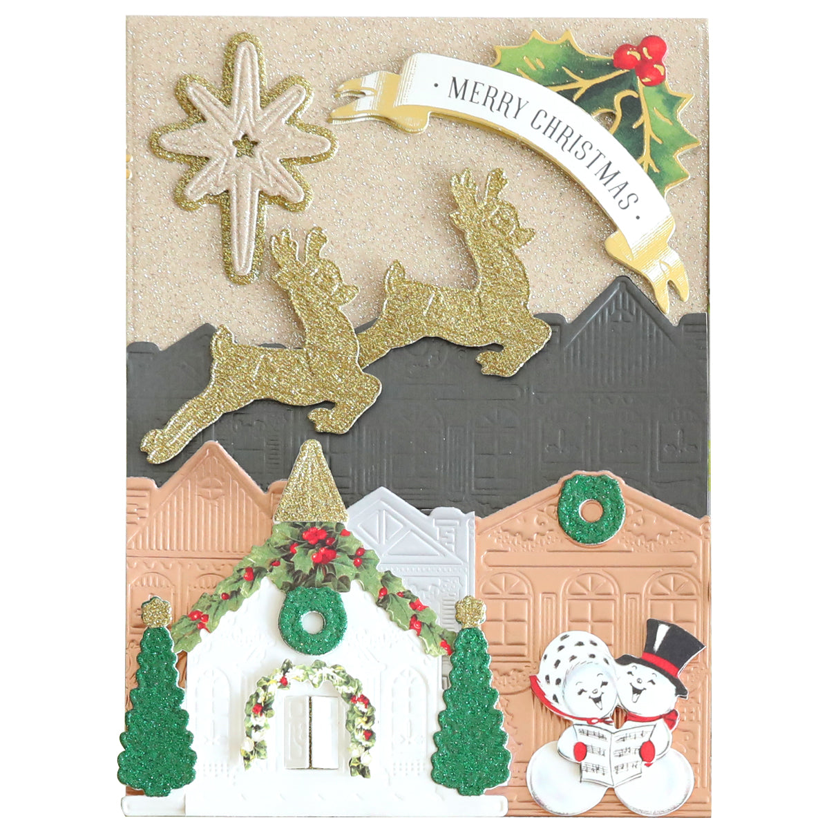 A festive Christmas card made from Luxury Glitter Cardstock featuring glittery reindeer, a star, houses, a wreath, a holly sprig, and a snowy chapel with two snowmen holding a "Merry Christmas" banner.