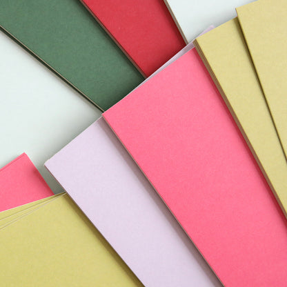 Featuring a variety of overlapping colored paper sheets in shades of green, red, pink, lilac, and yellow, the Luxury Solid Cardstock is perfect for adding a touch of elegance to your embossing or die-cutting projects.